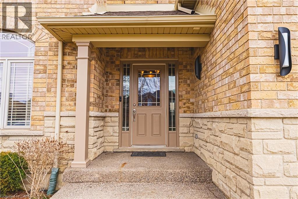 Entrance to property featuring stone siding and covered porch - 120 Valiant Circle, Hamilton, ON - Outdoor With Exterior