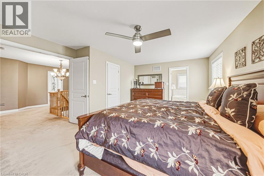 Carpeted bedroom with hanging lights and ceiling fan - 120 Valiant Circle, Hamilton, ON - Indoor Photo Showing Bedroom