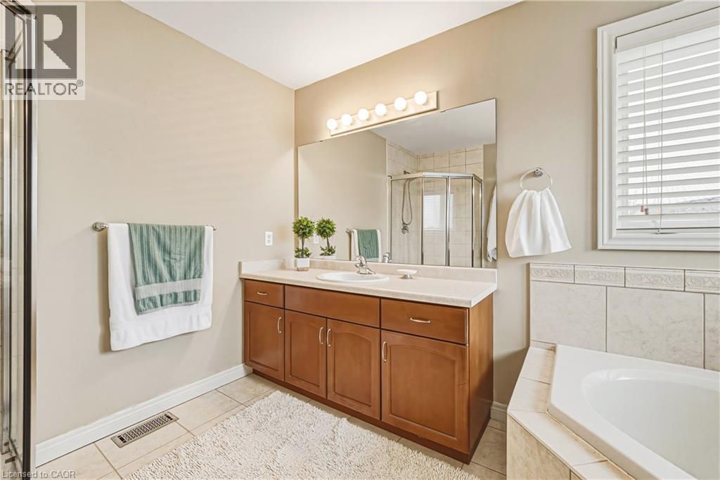 Full bathroom with vanity, a stall shower, light tile patterned floors, and a bath - 120 Valiant Circle, Hamilton, ON - Indoor Photo Showing Bathroom