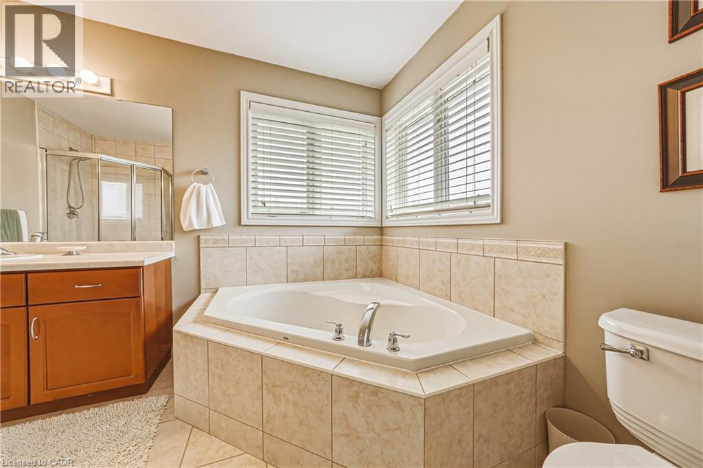 Bathroom featuring a stall shower, light tile patterned floors, a garden tub, and vanity - 120 Valiant Circle, Hamilton, ON - Indoor Photo Showing Bathroom