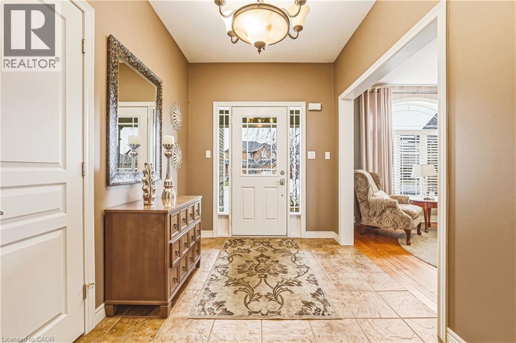 Entrance foyer with baseboards and a chandelier - 120 Valiant Circle, Hamilton, ON - Indoor Photo Showing Other Room