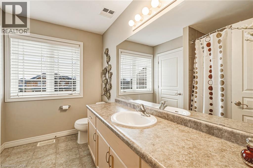 Full bath featuring a shower with curtain, vanity, and light tile patterned flooring - 120 Valiant Circle, Hamilton, ON - Indoor Photo Showing Bathroom