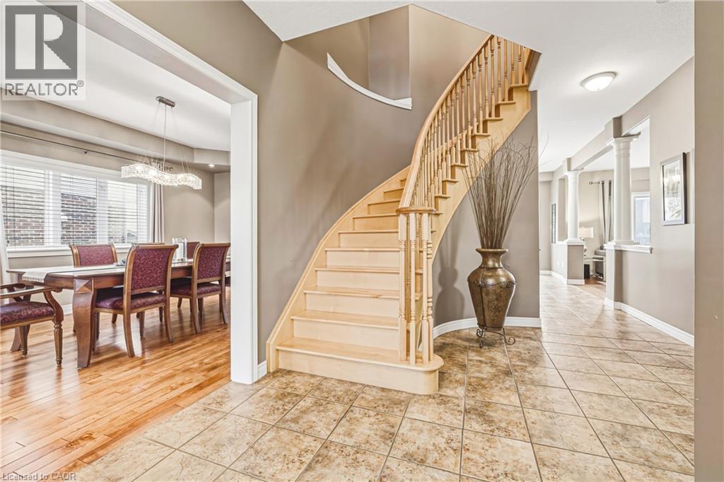 Stairs featuring healthy amount of natural light, ornate columns, and tile patterned flooring - 120 Valiant Circle, Hamilton, ON - Indoor Photo Showing Other Room