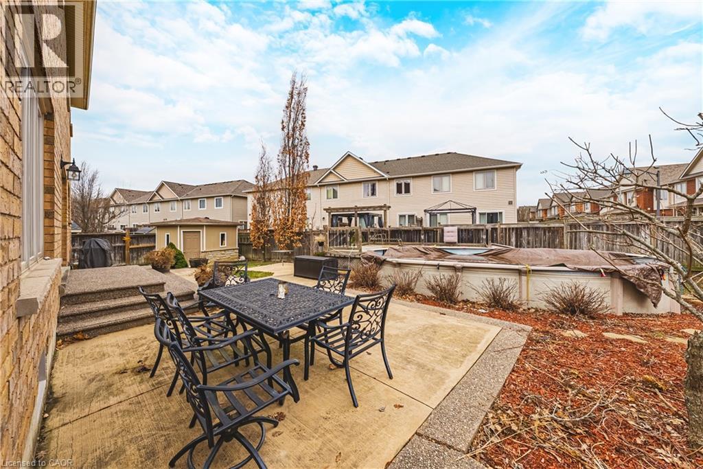 Fenced backyard featuring a patio area, a swimming pool, and a residential view - 120 Valiant Circle, Hamilton, ON - Outdoor