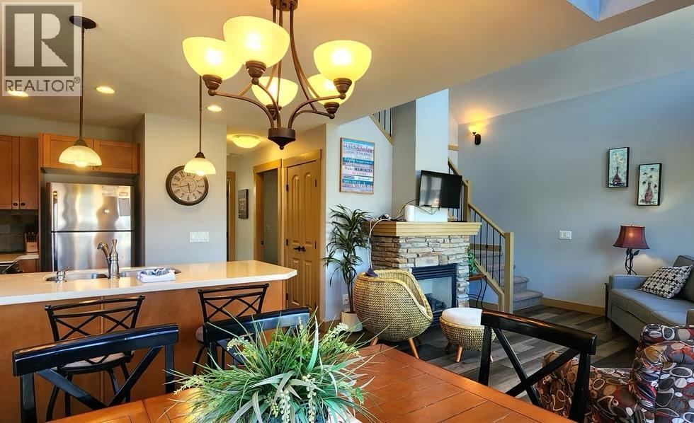 6844 Madrid Way Unit# 321, Fintry, BC - Indoor Photo Showing Dining Room With Fireplace