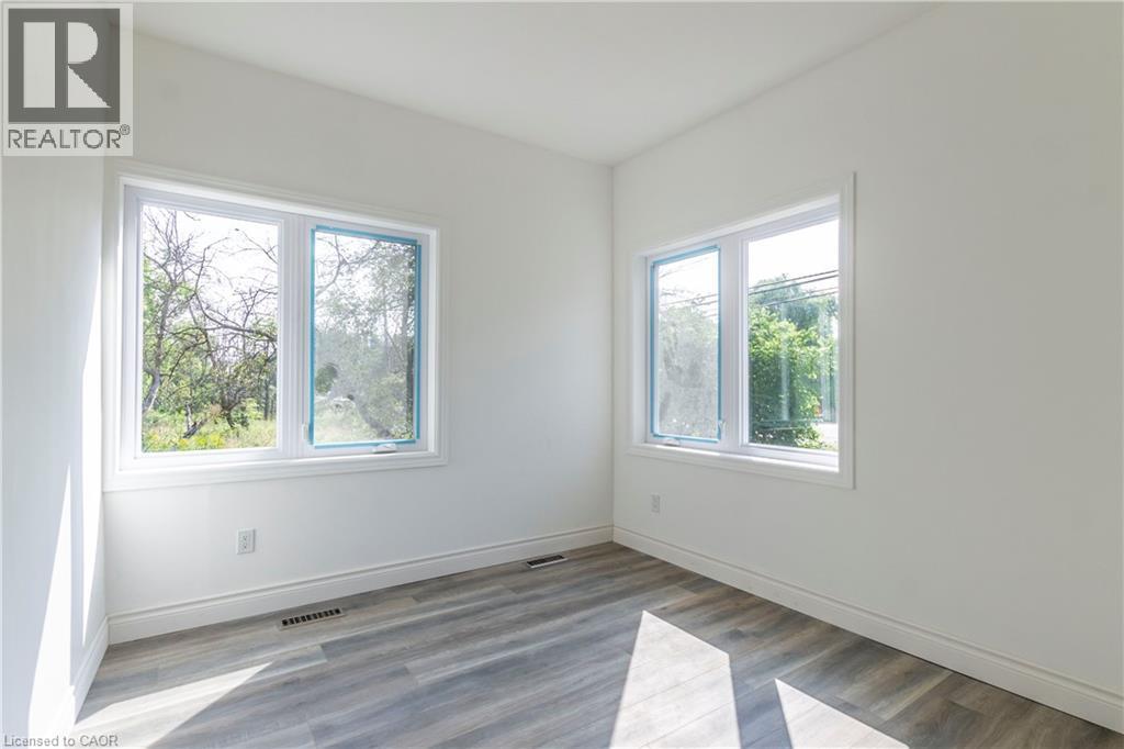 Unfurnished room featuring wood finished floors - 1411 E 56 Highway, Glanbrook, ON - Indoor Photo Showing Other Room