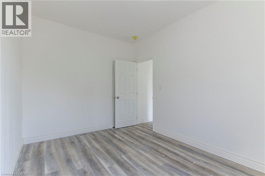 Spare room featuring light wood-type flooring and baseboards - 1411 E 56 Highway, Glanbrook, ON - Indoor Photo Showing Other Room