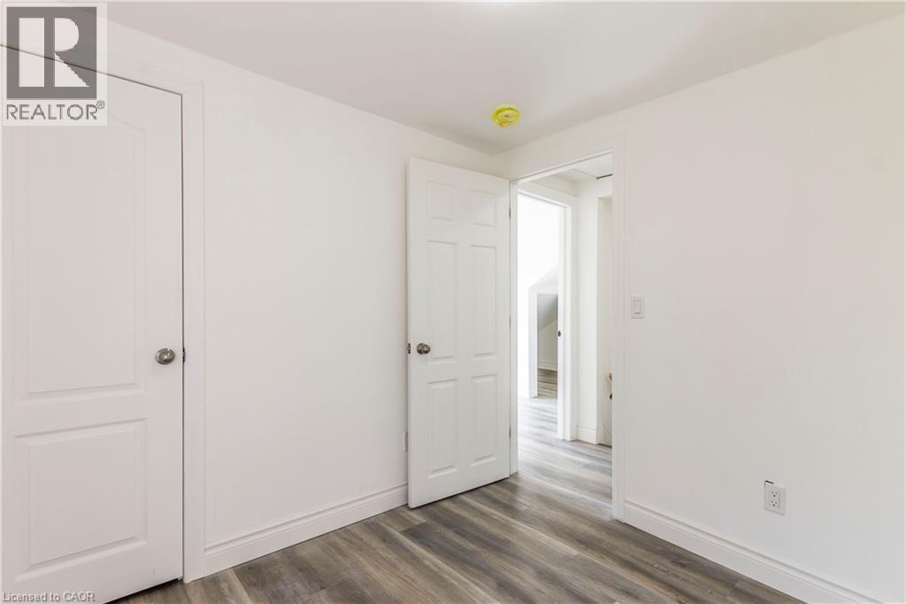 Unfurnished bedroom featuring dark wood finished floors and baseboards - 1411 E 56 Highway, Glanbrook, ON - Indoor Photo Showing Other Room