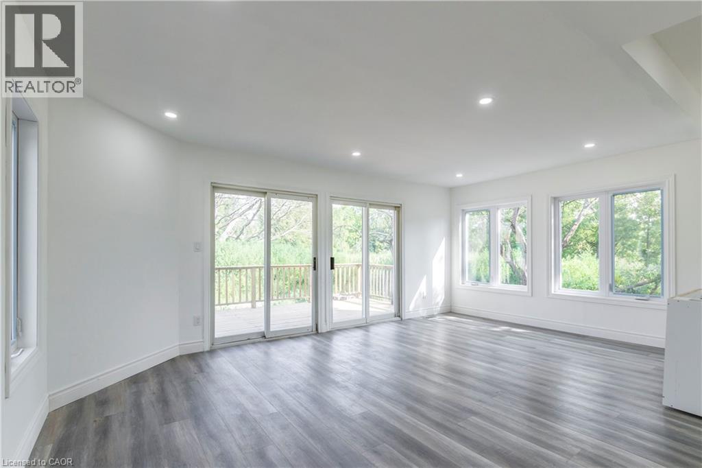 Unfurnished living room with dark wood finished floors and recessed lighting - 1411 E 56 Highway, Glanbrook, ON - Indoor Photo Showing Other Room