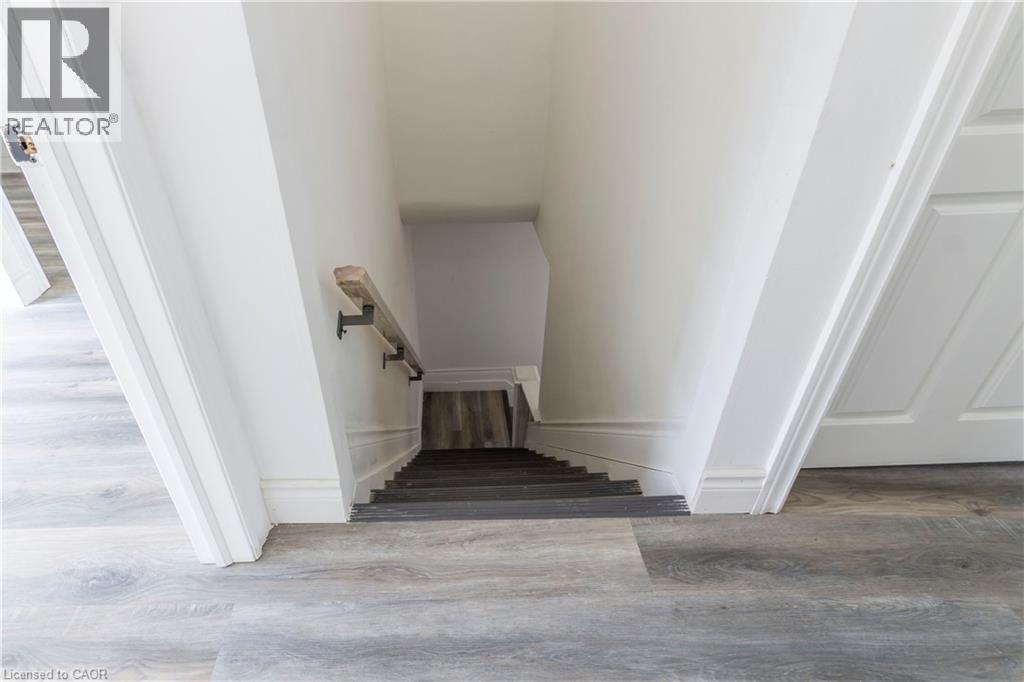 Stairway with wood finished floors - 1411 E 56 Highway, Glanbrook, ON - Indoor Photo Showing Other Room