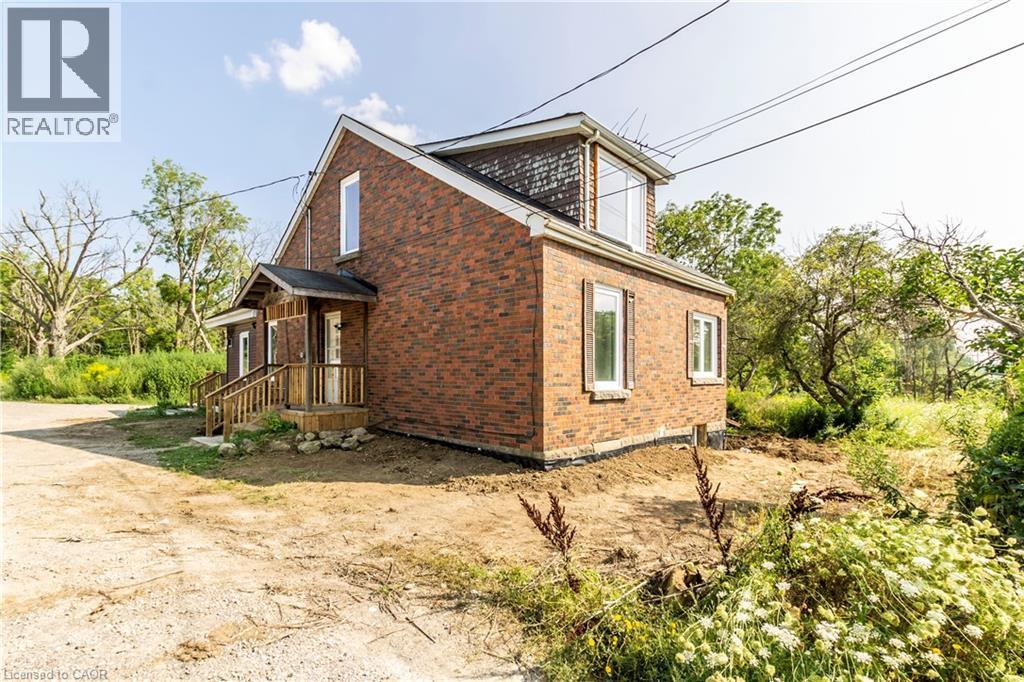View of property exterior featuring brick siding - 1411 E 56 Highway, Glanbrook, ON - Outdoor With Exterior
