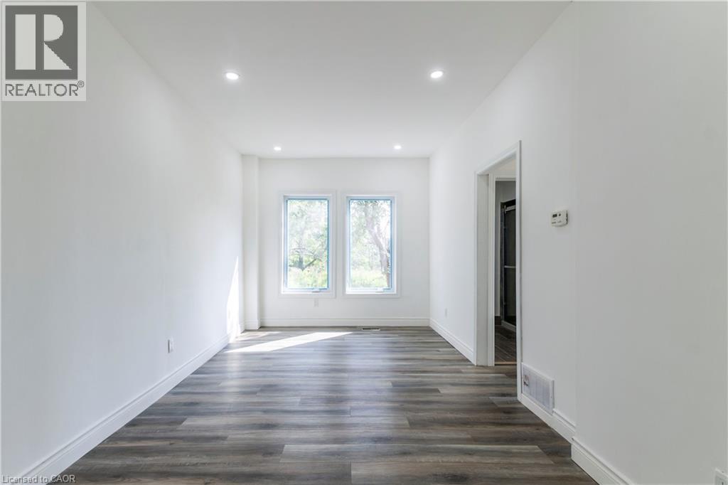 Empty room featuring dark wood-type flooring and recessed lighting - 1411 E 56 Highway, Glanbrook, ON - Indoor Photo Showing Other Room