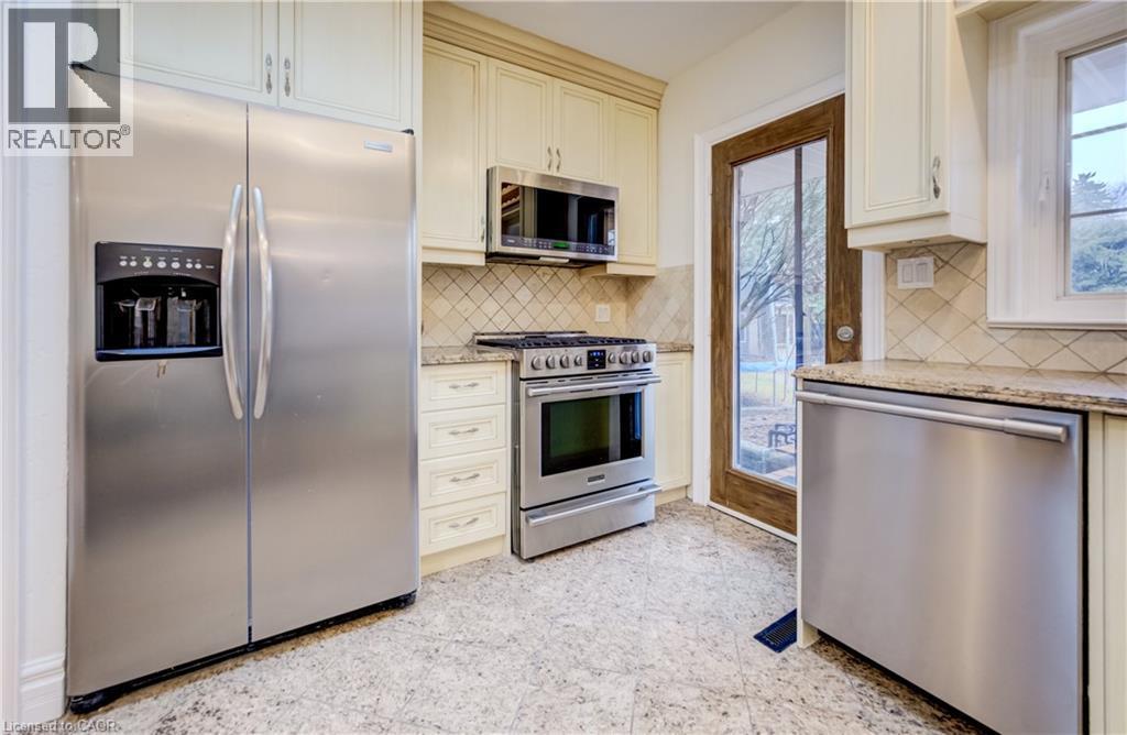 Kitchen with stainless steel appliances and light stone countertops - 655 Ellengale Road, Burlington, ON - Indoor Photo Showing Kitchen