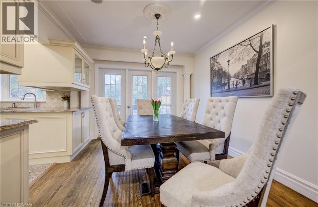Dining space featuring a chandelier, ornamental molding, and light wood finished floors - 655 Ellengale Road, Burlington, ON - Indoor Photo Showing Dining Room