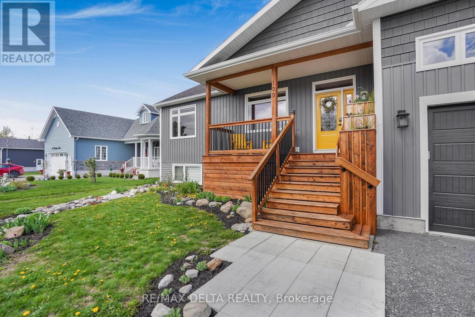 Nicely-landscaped, front deck. - 100 Pendleton Street, Champlain, ON - Outdoor With Deck Patio Veranda