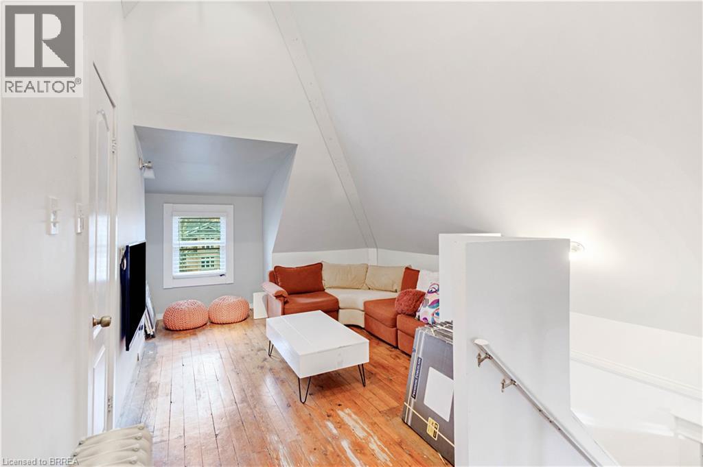 Sitting room featuring light wood finished floors, an upstairs landing, and lofted ceiling - 134 Sherman Avenue S, Hamilton, ON - Indoor Photo Showing Other Room