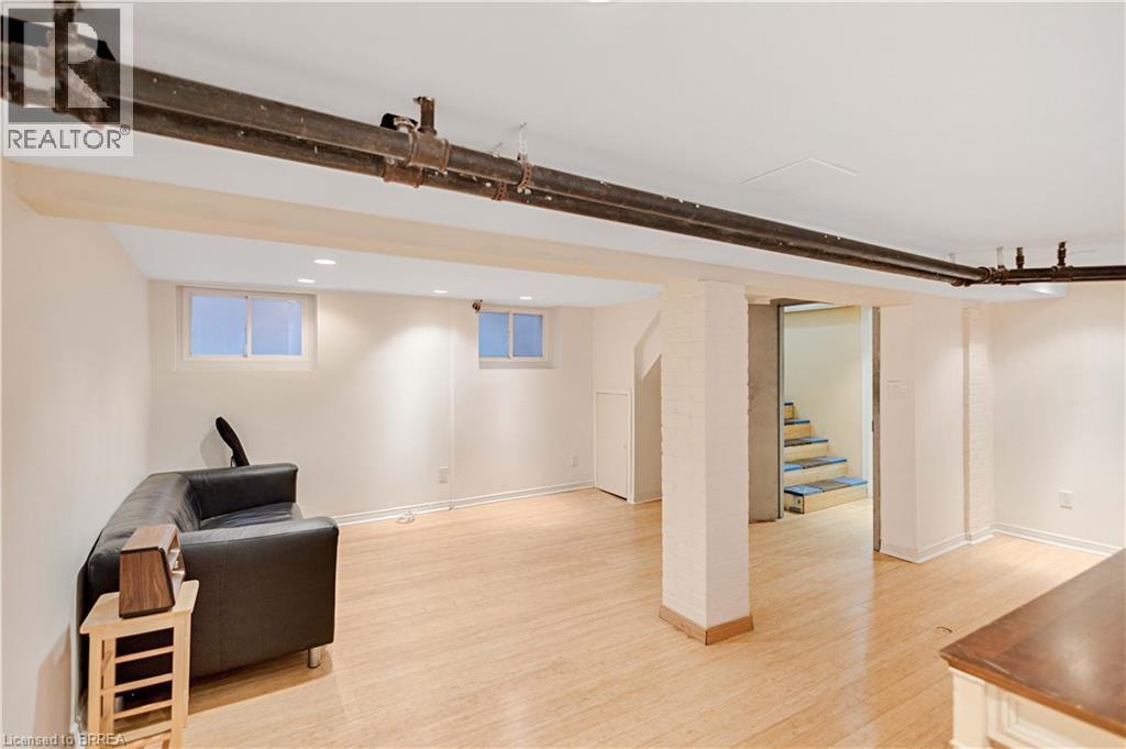 Living area with light wood-style floors, stairway, and recessed lighting - 134 Sherman Avenue S, Hamilton, ON - Indoor Photo Showing Other Room