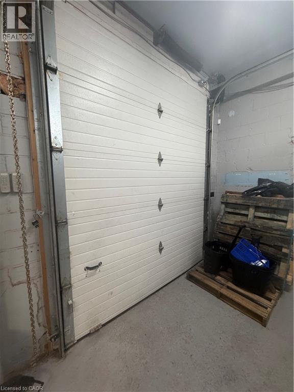 Garage featuring concrete block wall - 10 Sanford Avenue N, Hamilton, ON
