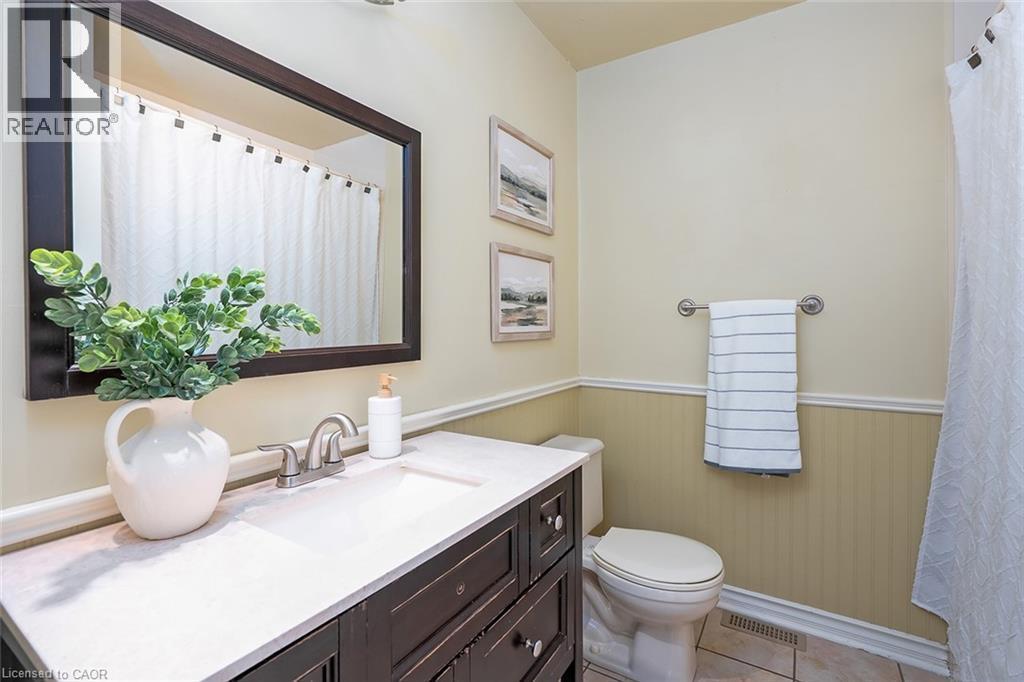 Bathroom featuring vanity, a wainscoted wall, a shower with shower curtain, and light tile patterned flooring - 1278 Consort Crescent, Burlington, ON - Indoor Photo Showing Bathroom