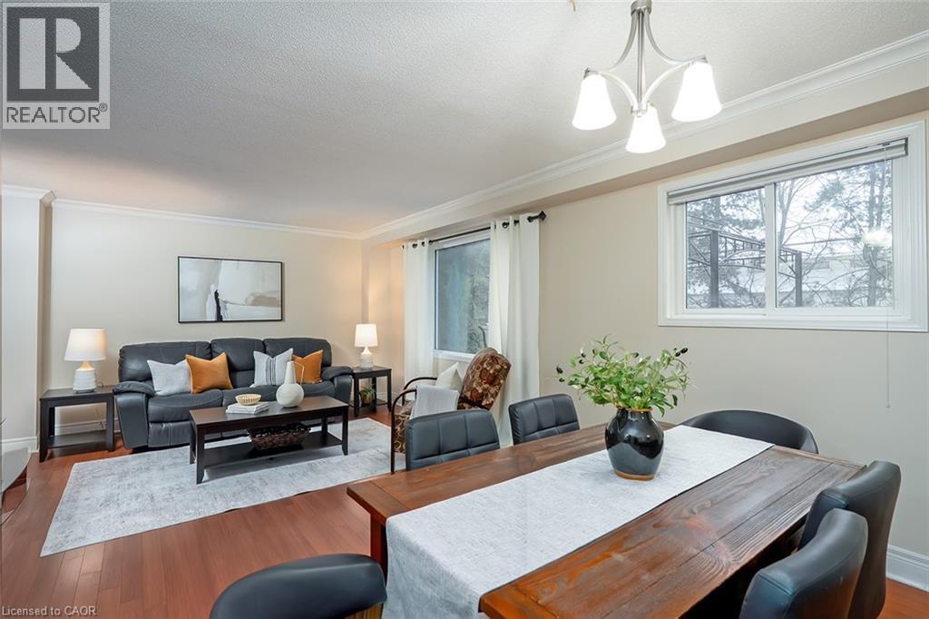 Dining room featuring wood finished floors, ornamental molding, a chandelier, and a textured ceiling - 1278 Consort Crescent, Burlington, ON - Indoor