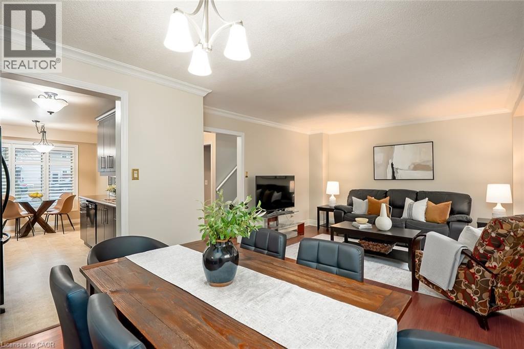Dining area with crown molding, hanging lights, light wood finished floors, and a textured ceiling - 1278 Consort Crescent, Burlington, ON - Indoor