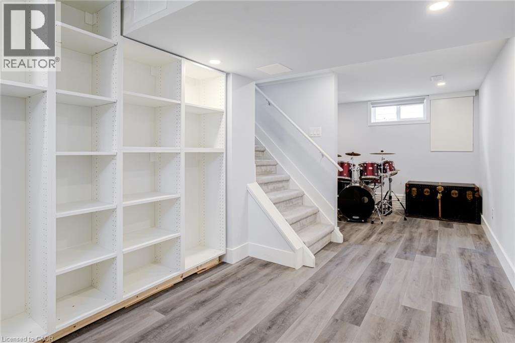 Basement with light wood-style floors and recessed lighting - 624 Burgess Avenue, Hamilton, ON - Indoor