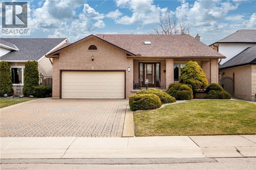 Single story home featuring brick siding, a garage, decorative driveway, and roof with shingles - 57 Derek Drive, Hamilton, ON - Outdoor