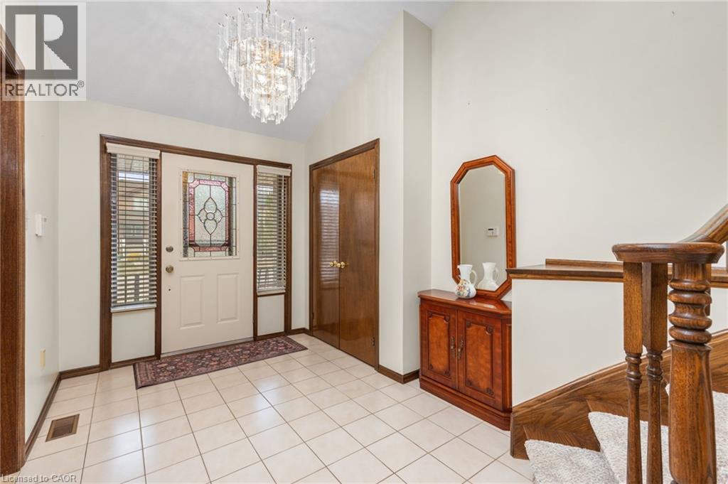 Entryway featuring a chandelier, vaulted ceiling, and light tile patterned flooring - 57 Derek Drive, Hamilton, ON - Indoor Photo Showing Other Room