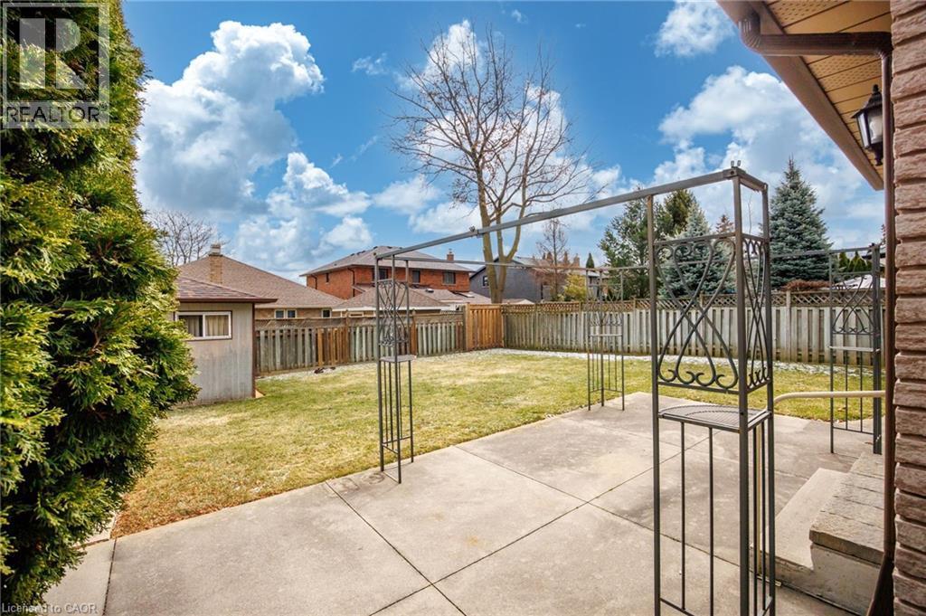Fenced backyard featuring a patio and a residential view - 57 Derek Drive, Hamilton, ON - Outdoor