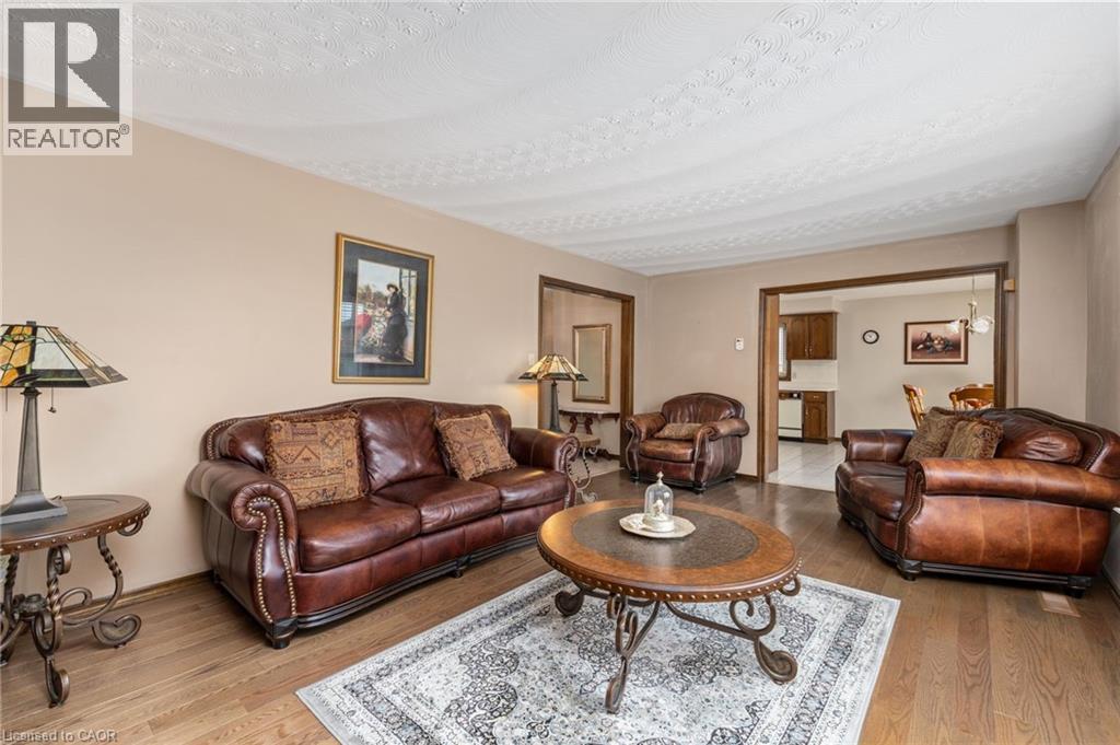 Living area with light wood-type flooring and a textured ceiling - 57 Derek Drive, Hamilton, ON - Indoor Photo Showing Living Room
