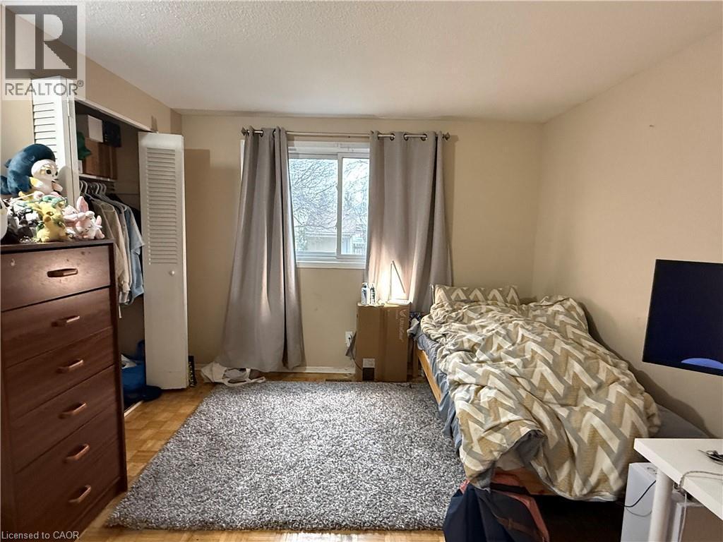Bedroom with parquet flooring, a closet, and a textured ceiling - 60 Helene Crescent, Waterloo, ON - Indoor Photo Showing Bedroom