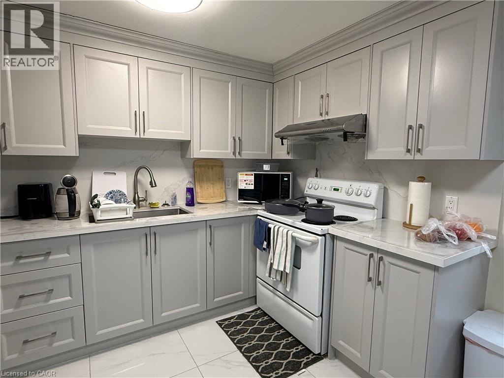 Kitchen featuring white electric range, gray cabinets, light marble finish flooring, and light stone counters - 60 Helene Crescent, Waterloo, ON - Indoor Photo Showing Kitchen
