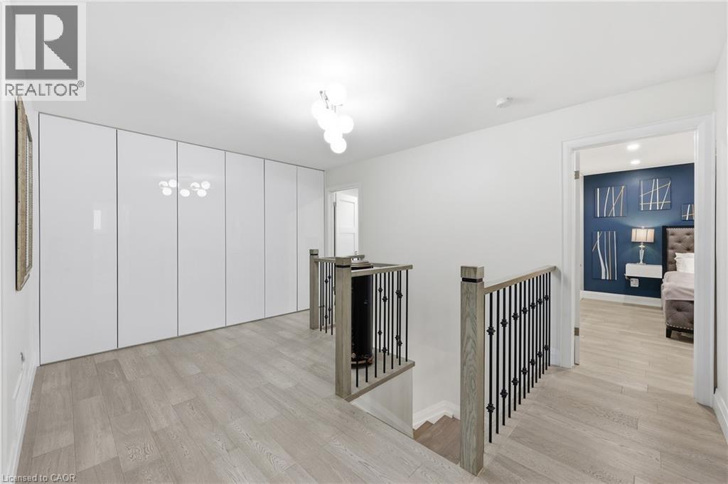 Hall with an upstairs landing and light wood-type flooring - 273 Bryant Crescent, Burlington, ON - Indoor Photo Showing Other Room