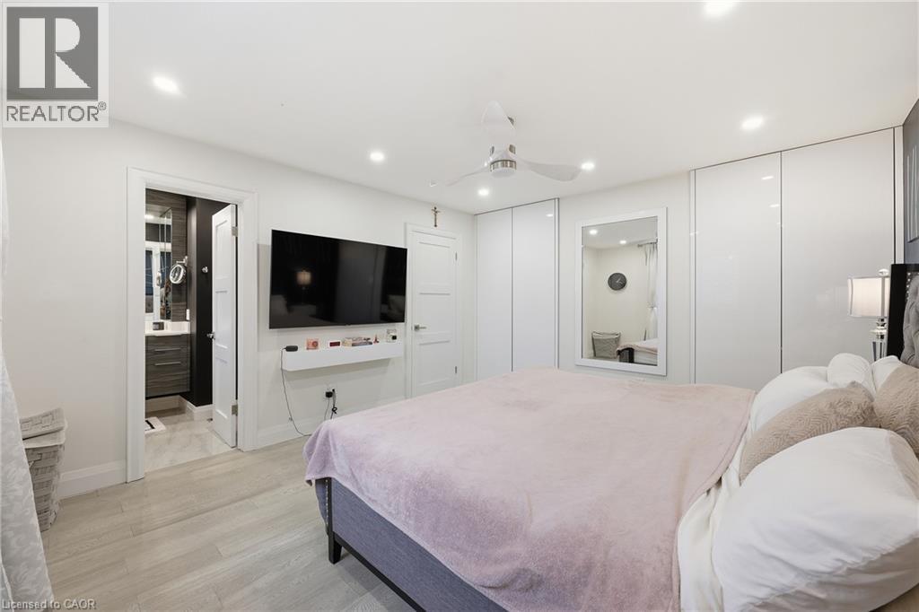 Bedroom with light wood-style floors, multiple closets, recessed lighting, a ceiling fan, and ensuite bathroom - 273 Bryant Crescent, Burlington, ON - Indoor Photo Showing Bedroom