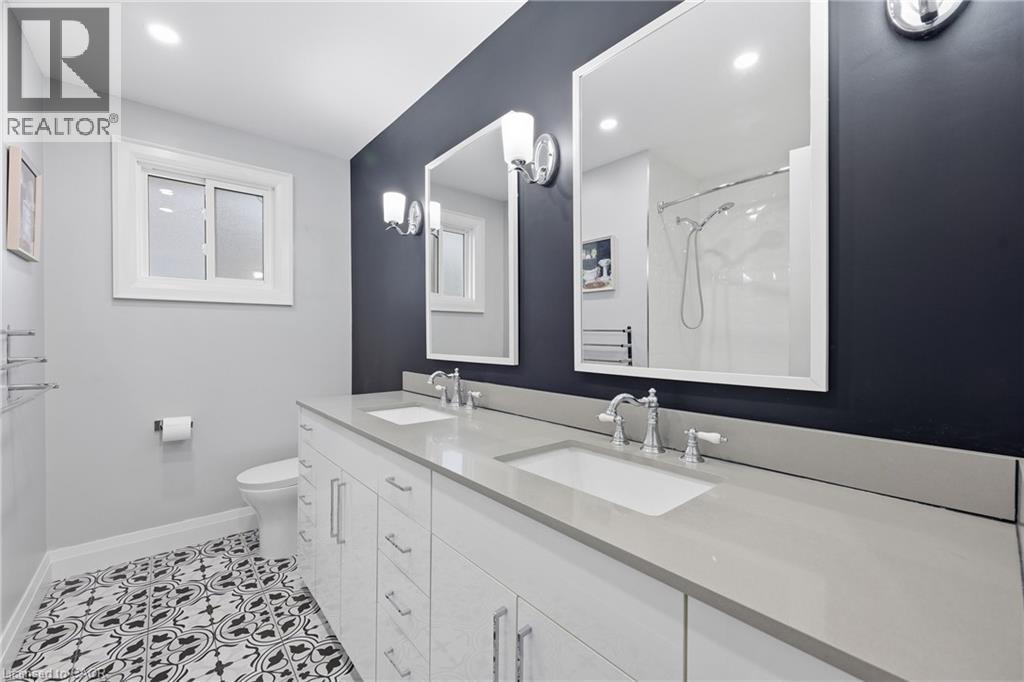 Bathroom featuring double vanity, a shower, light tile patterned floors, and recessed lighting - 273 Bryant Crescent, Burlington, ON - Indoor Photo Showing Bathroom
