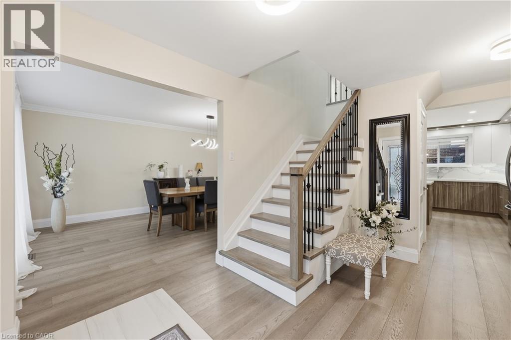 Stairway featuring wood finished floors and a chandelier - 273 Bryant Crescent, Burlington, ON - Indoor
