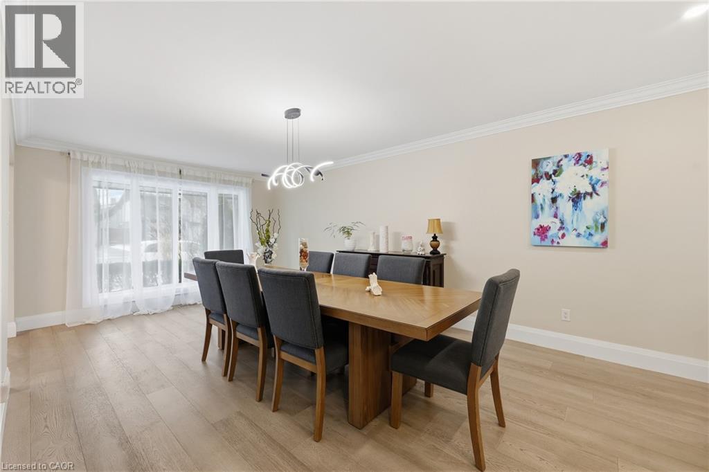 Dining space with ornamental molding, light wood-type flooring, and hanging lights - 273 Bryant Crescent, Burlington, ON - Indoor Photo Showing Dining Room