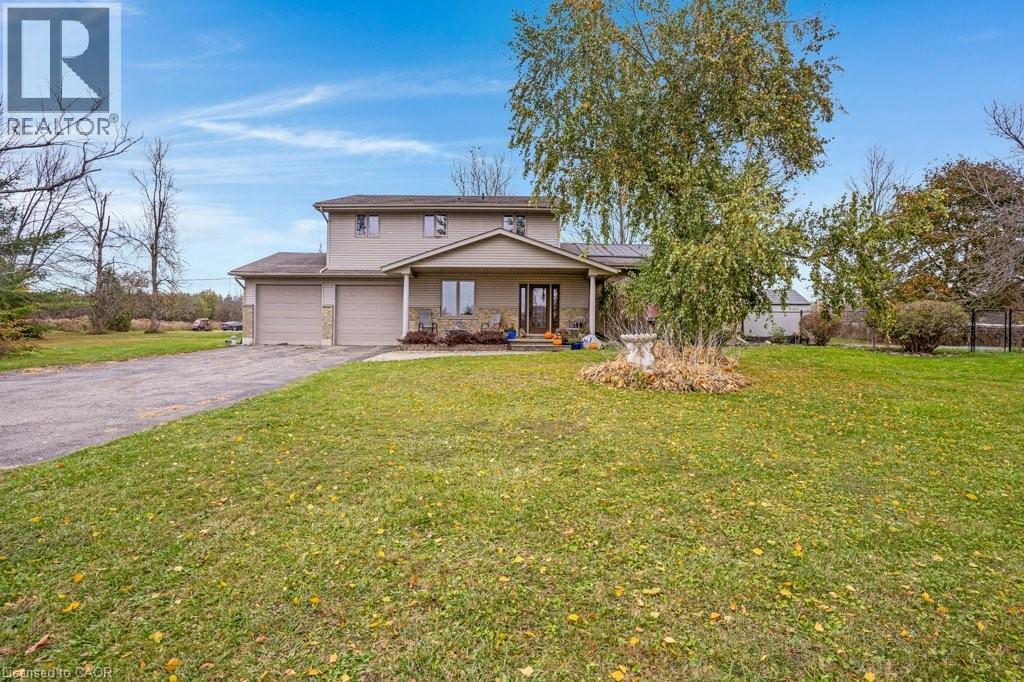 Traditional-style house featuring a porch, a front lawn, driveway, and solar panels - 5511 Second Line, Erin, ON - Outdoor With Deck Patio Veranda