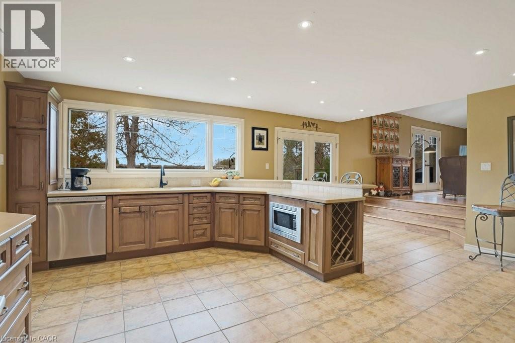 Kitchen featuring wood finish cabinetry, stainless steel appliances, a peninsula, open floor plan, and recessed lighting - 5511 Second Line, Erin, ON - Indoor Photo Showing Kitchen