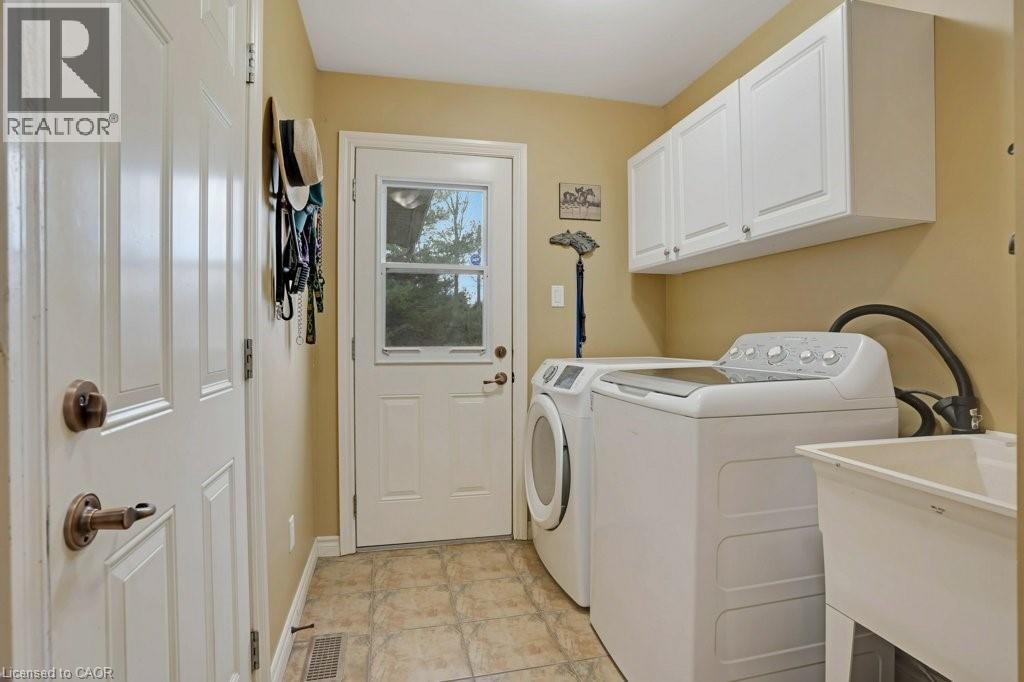 Laundry area featuring cabinet space and separate washer and dryer - 5511 Second Line, Erin, ON - Indoor Photo Showing Laundry Room
