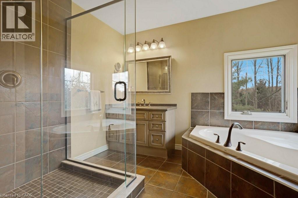 Bathroom featuring vanity, a stall shower, a bath, and dark tile patterned floors - 5511 Second Line, Erin, ON - Indoor Photo Showing Bathroom