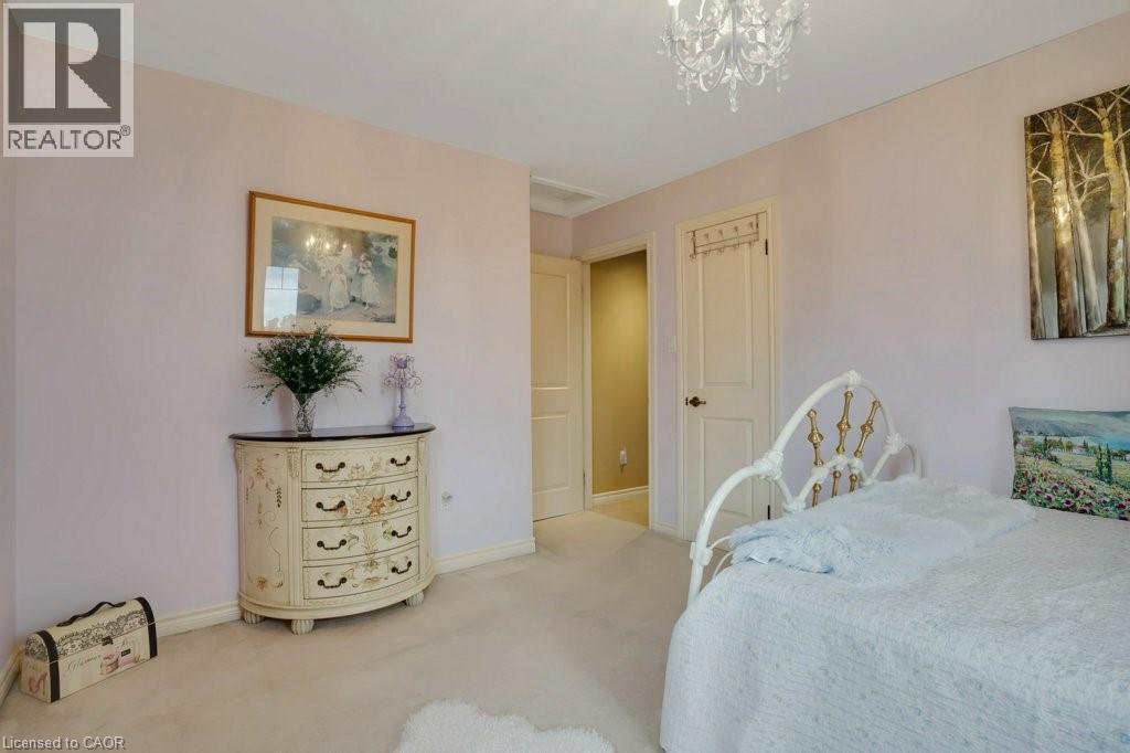 Bedroom featuring light colored carpet and hanging lights - 5511 Second Line, Erin, ON - Indoor Photo Showing Bedroom