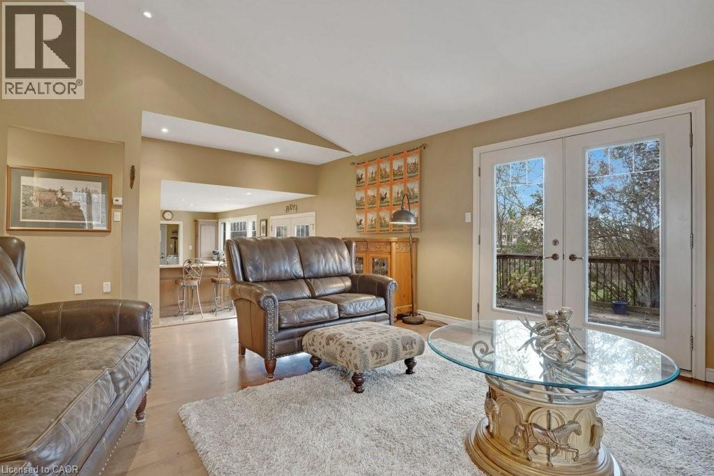 Living room featuring lofted ceiling, french doors, light wood-style flooring, and recessed lighting - 5511 Second Line, Erin, ON - Indoor Photo Showing Living Room