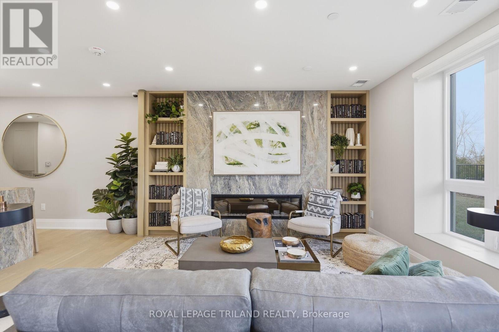 310 - 1560 Upper West Avenue, London South (South B), ON - Indoor Photo Showing Living Room With Fireplace