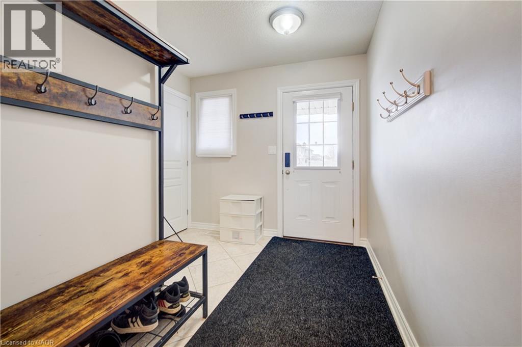Mudroom with light tile patterned flooring and a textured ceiling - 34 Harrison Street, Stratford, ON - Indoor Photo Showing Other Room