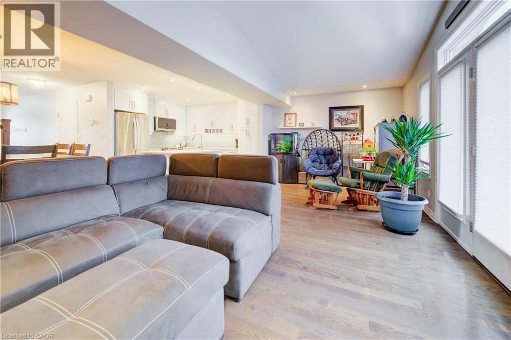 Living area featuring light wood-style floors, recessed lighting, and lofted ceiling - 34 Harrison Street, Stratford, ON - Indoor Photo Showing Living Room