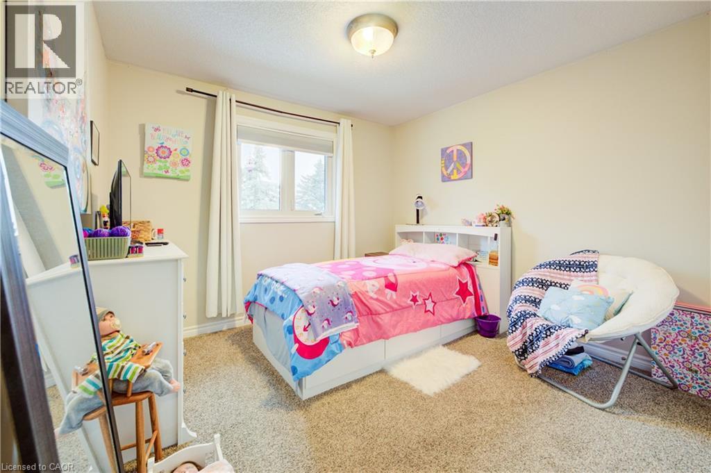 Bedroom with carpet and a textured ceiling - 34 Harrison Street, Stratford, ON - Indoor Photo Showing Bedroom