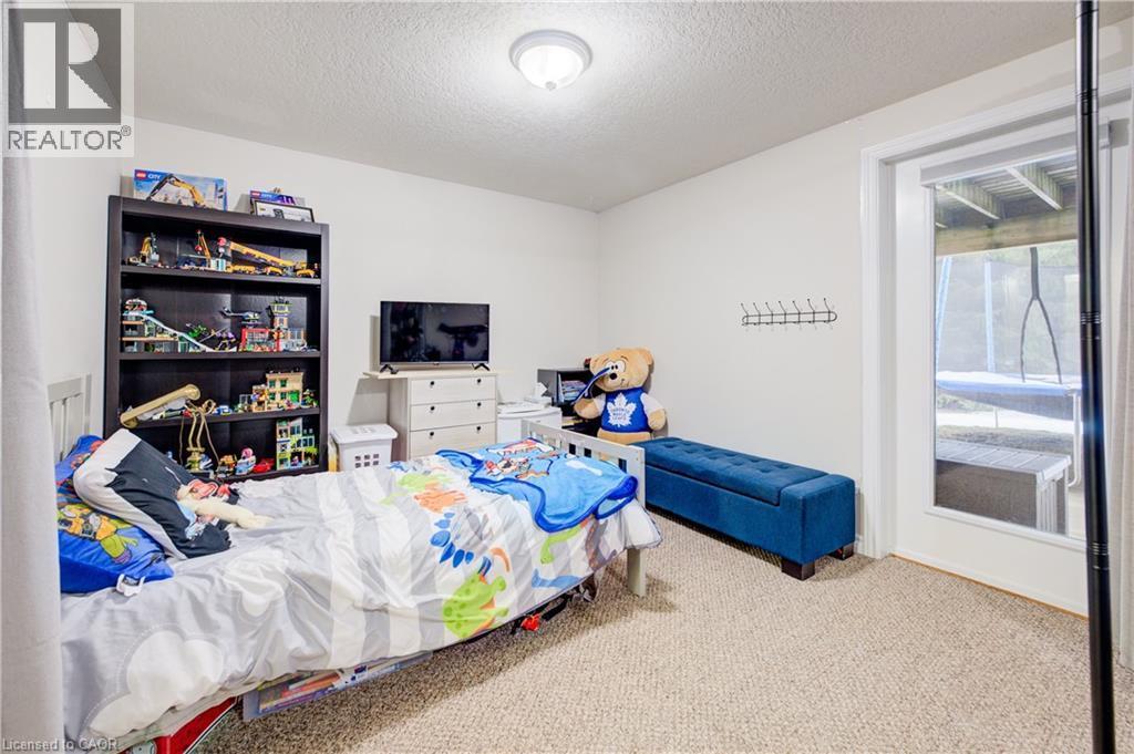 Carpeted bedroom featuring a textured ceiling - 34 Harrison Street, Stratford, ON - Indoor Photo Showing Bedroom