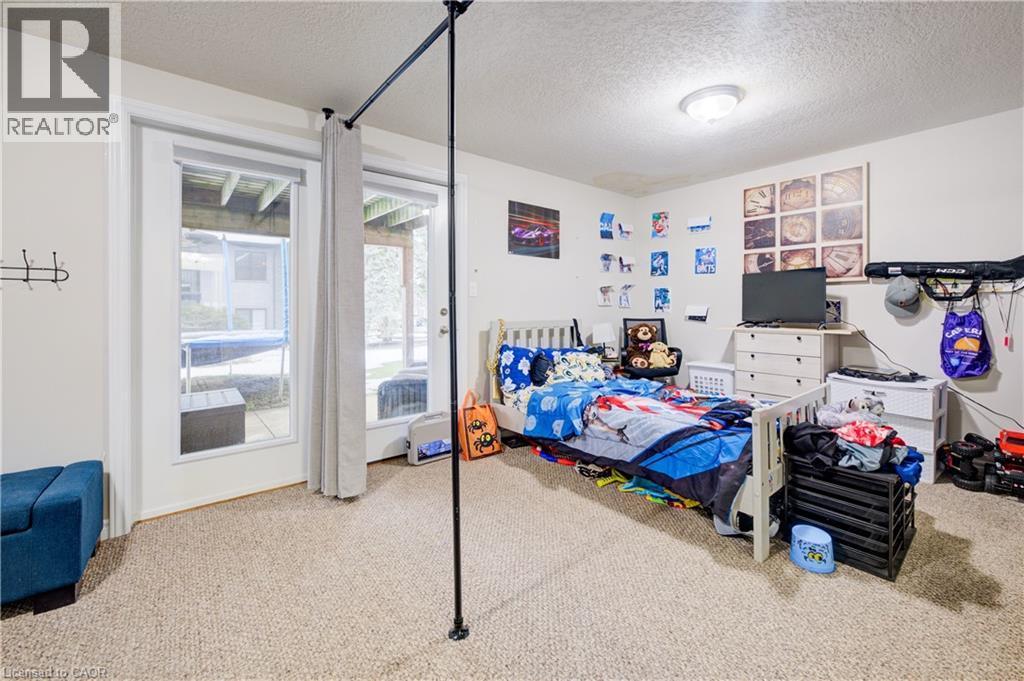 Bedroom with a textured ceiling and carpet - 34 Harrison Street, Stratford, ON - Indoor Photo Showing Bedroom