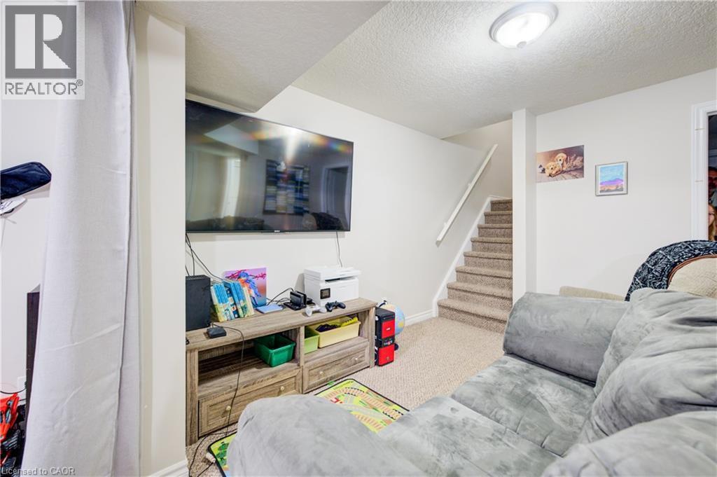 Living area with stairs, a textured ceiling, and carpet - 34 Harrison Street, Stratford, ON - Indoor